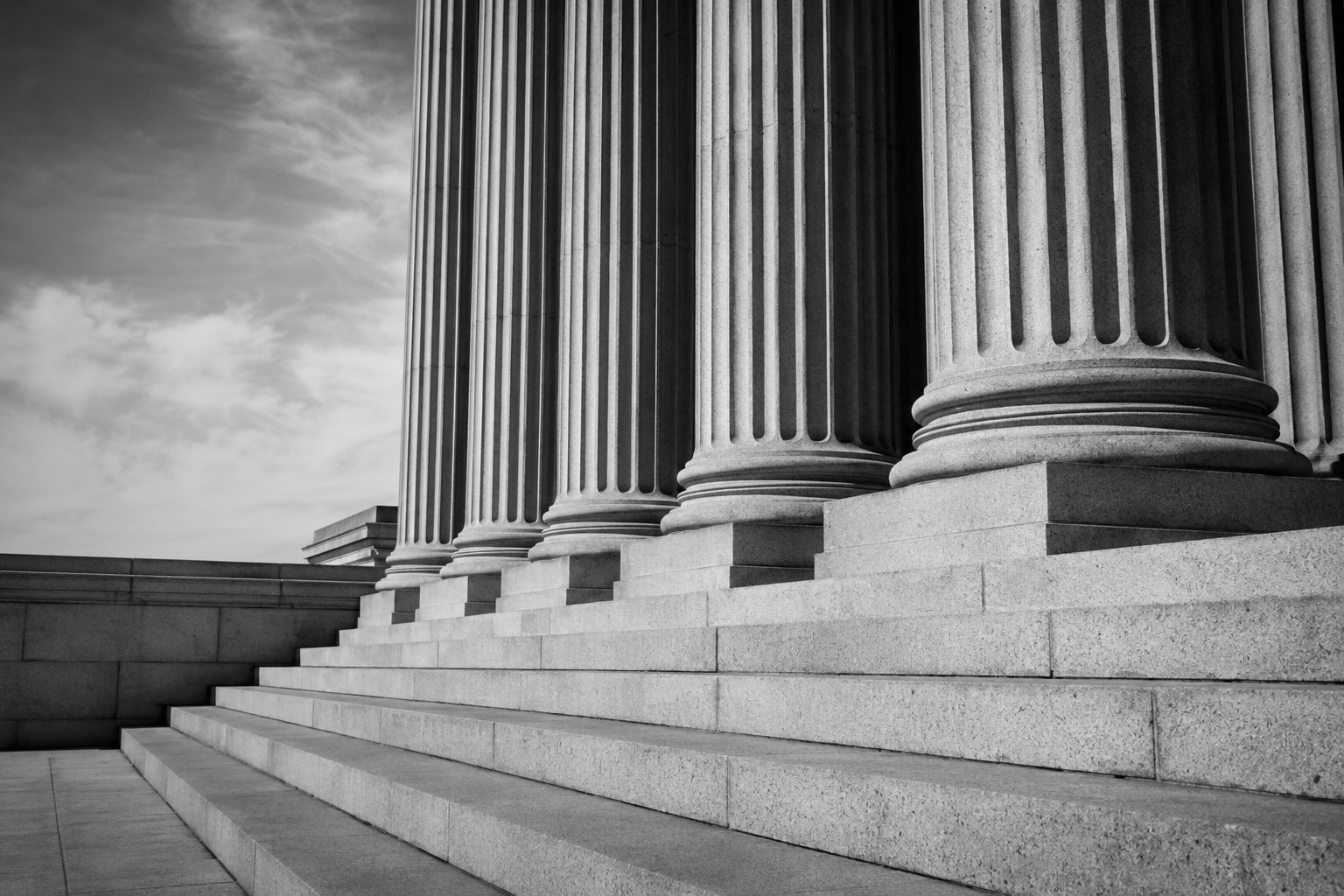 Stone courthouse columns and steps in black and white